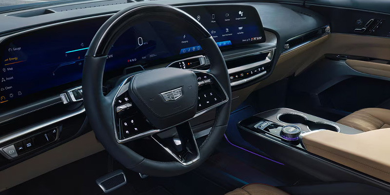Cadillac LYRIQ cabin showing SkyGlass roof and ambient lighting.