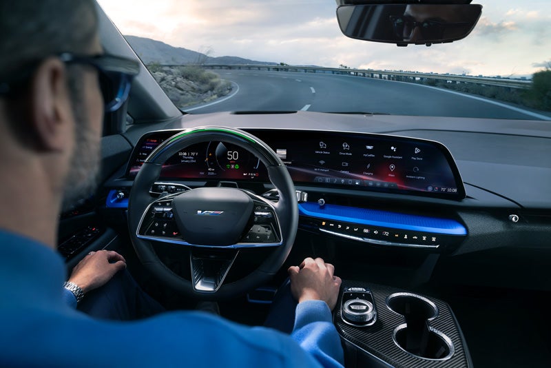 Front View of the 2026 OPTIQ-V Driving Through the Dusk Utilizing its Headlights | Hudson Cadillac in Poughkeepsie NY