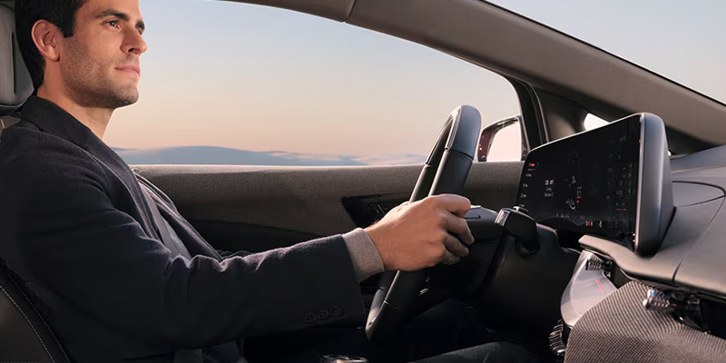 Hands on wheel inside 2026 Cadillac OPTIQ