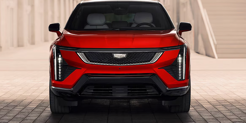 Front of red 2026 Cadillac OPTIQ featuring Cadillac logo