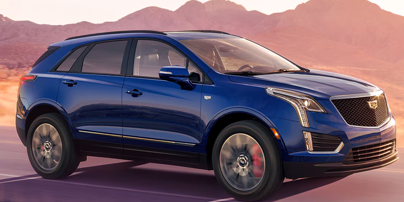Blue Cadillac XT5 driving near mountains in Poughkeepsie, NY